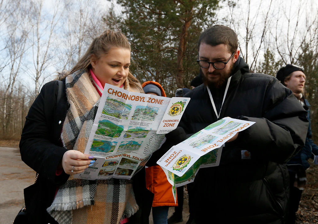 Tourists look at the Chernobyl zone map